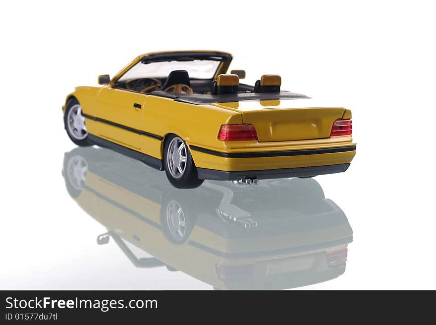 Yellow car with reflection. Studio shot