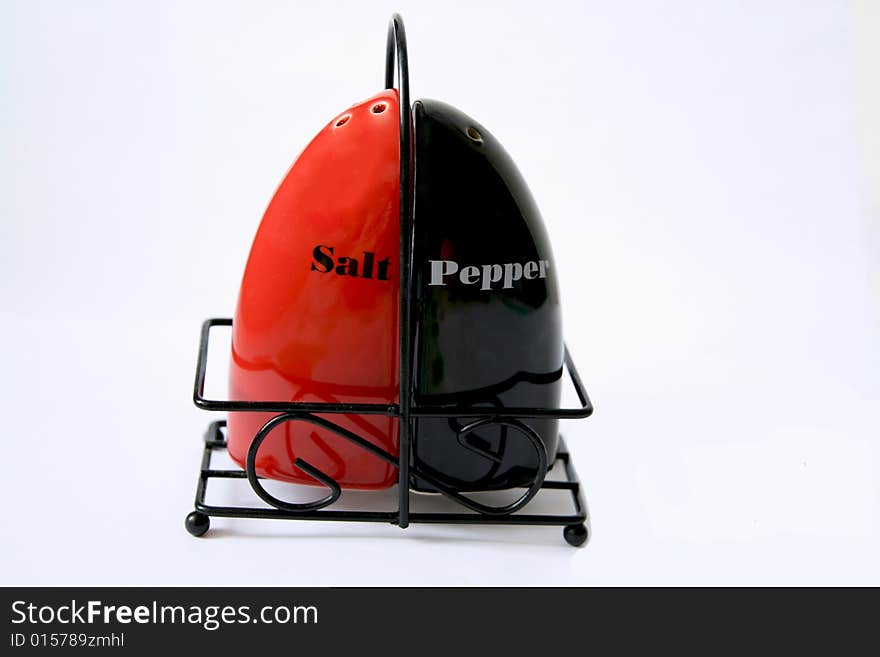 The complete set of a saltcellar and pepperbox isolated on a white background. The complete set of a saltcellar and pepperbox isolated on a white background