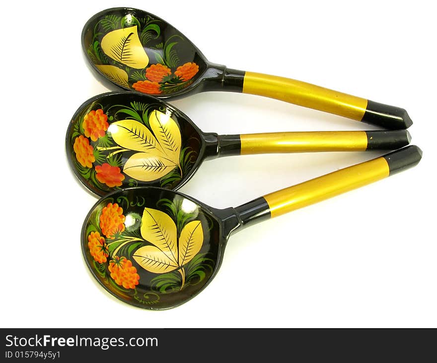 Three beautiful wooden spoons lie on a white background