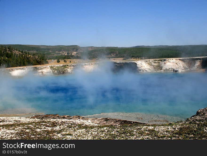 Blue Pool with geysers in Yellowstone National Park