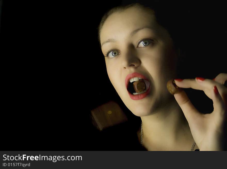 Woman with a dice on a black background with a dice