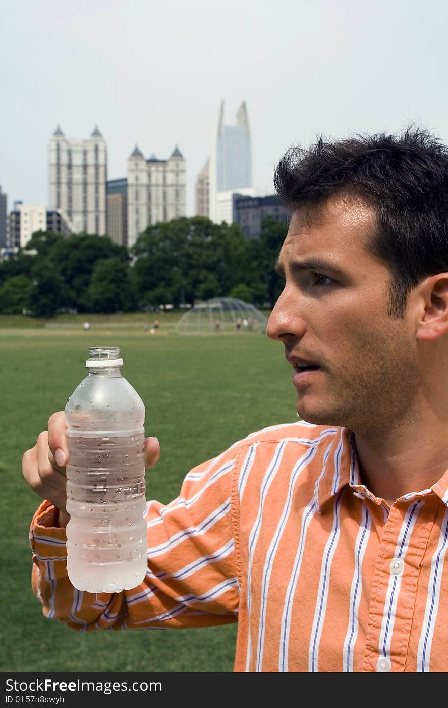 Man in park drinking water. Man in park drinking water