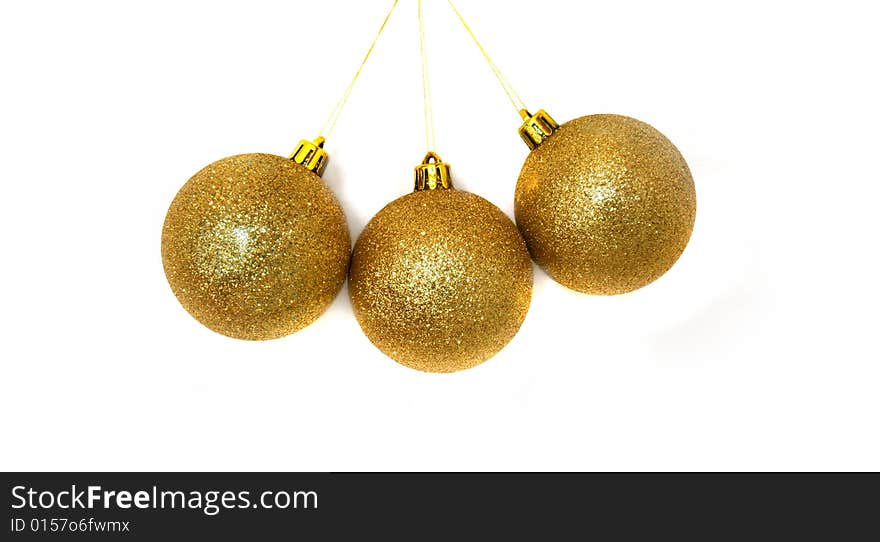 Three xmas balls over white