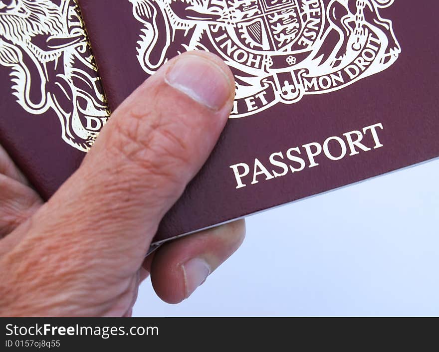 Male hand holding British 10 year passport. Male hand holding British 10 year passport