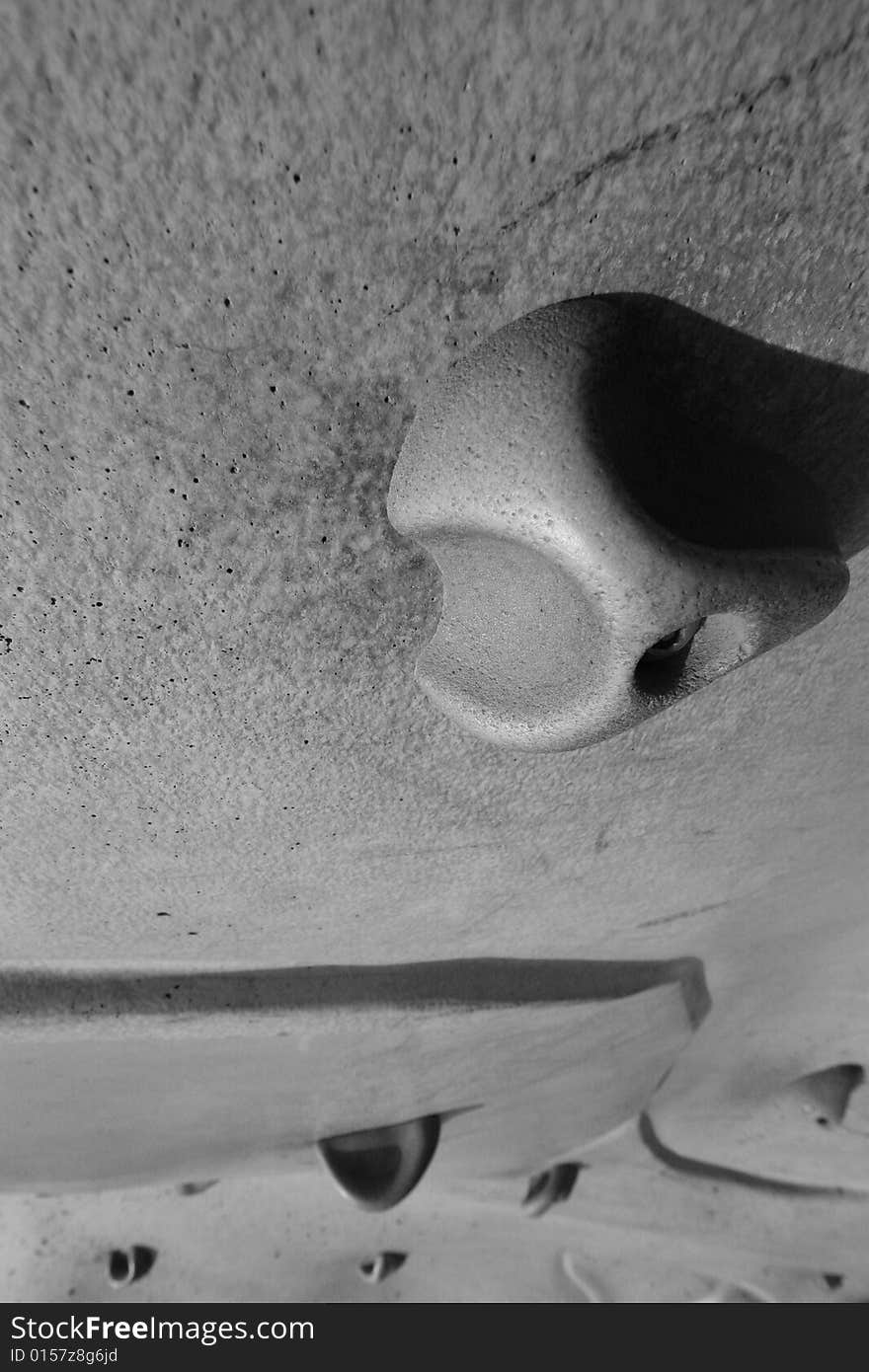 Close up of a rock climbing wall in black and white.