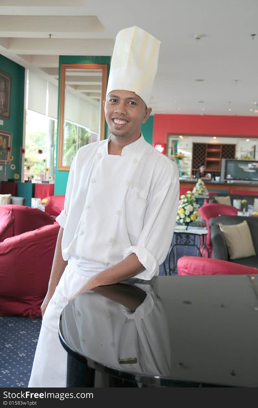 Chef standing at restaurant proud and smiling