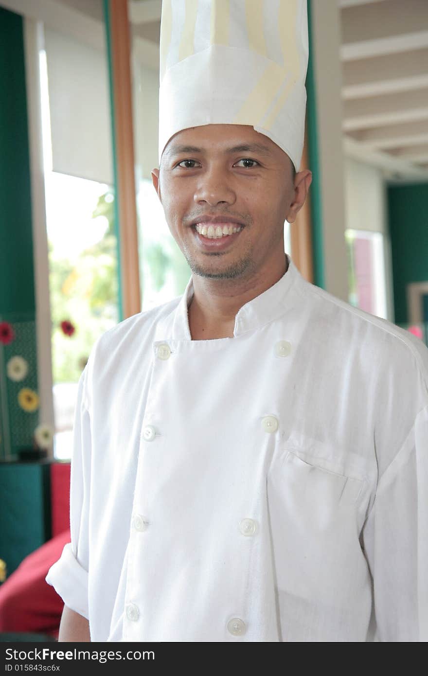 Chef standing at restaurant proud and smiling