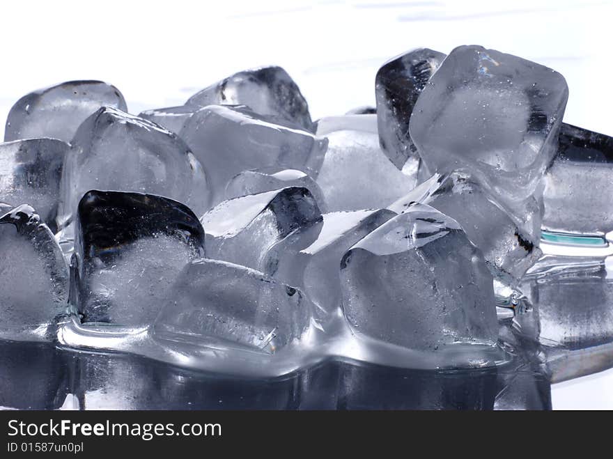 Ice cubes in smooth reflected background