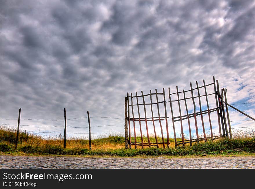 Beautiful hdr scene of a fence and cloudscape. Beautiful hdr scene of a fence and cloudscape