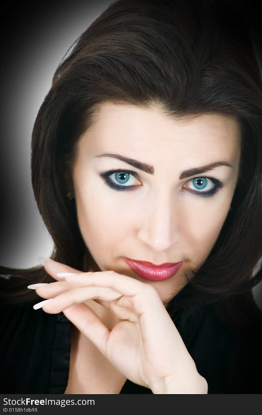 Portrait of the brunette with blue eye on black background