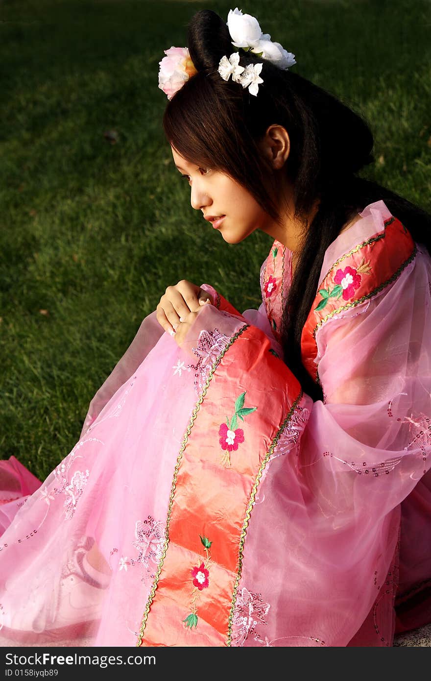 A girl in Chinese ancient dress. 
She is in pondering . A girl in Chinese ancient dress. 
She is in pondering ....