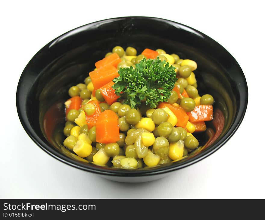 A black bowl with cooked vegetables. A black bowl with cooked vegetables