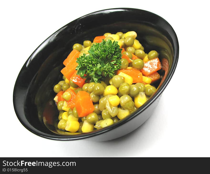 A bowl of vegetables tilted to the left