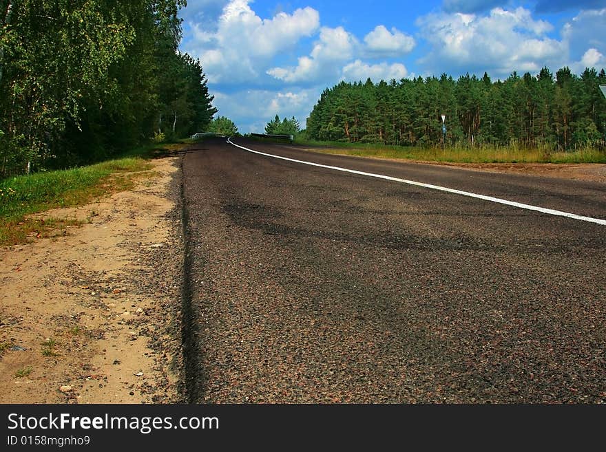 Road leaving afar a bright sunny day