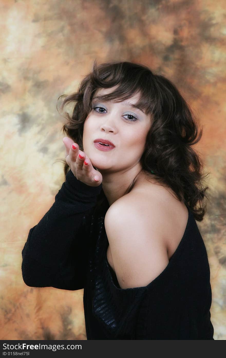 Portrait of the beautiful girl in studio on a brown background