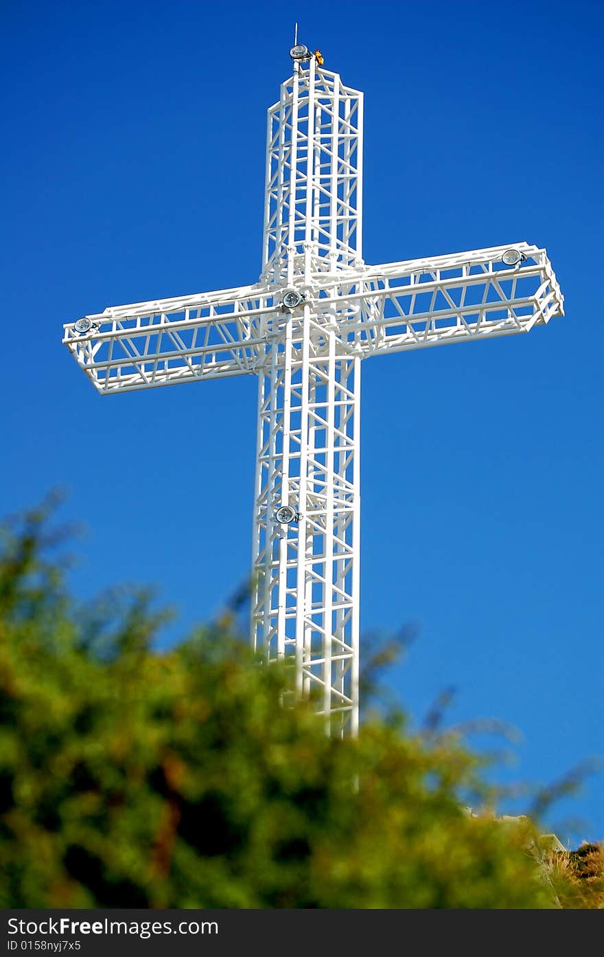 White steel cross on top of the mountain