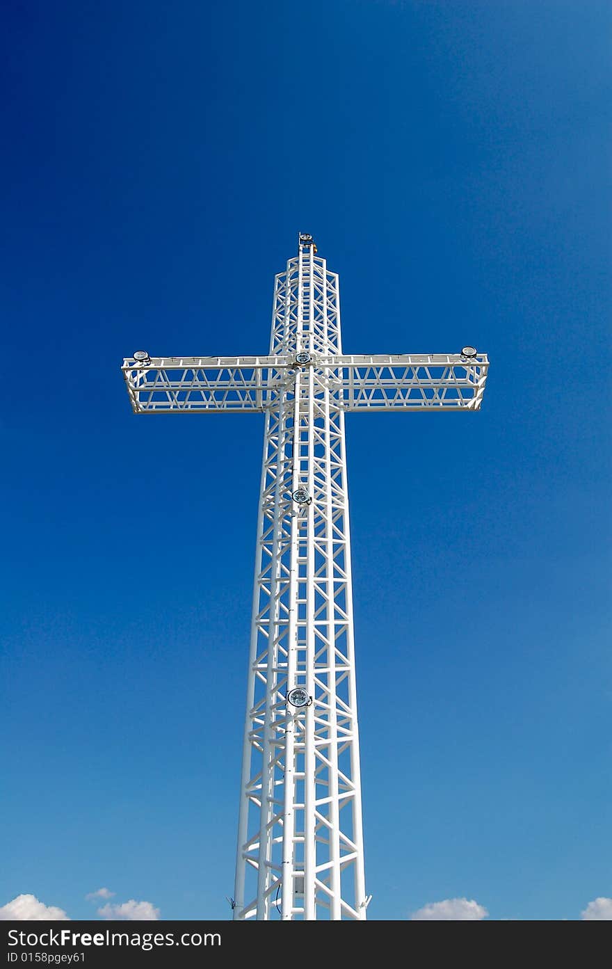 White steel cross on top of the mountain