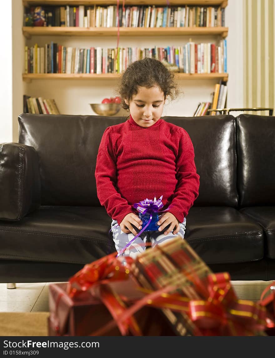 A little girl happy after receiving a present. A little girl happy after receiving a present