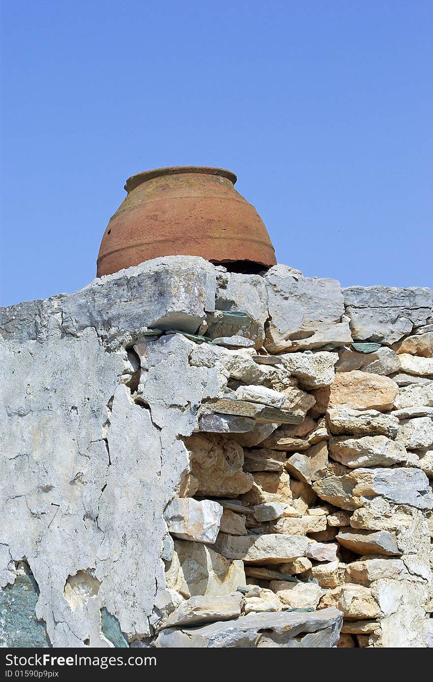 Vase set in old wall, Folegandros, Greece