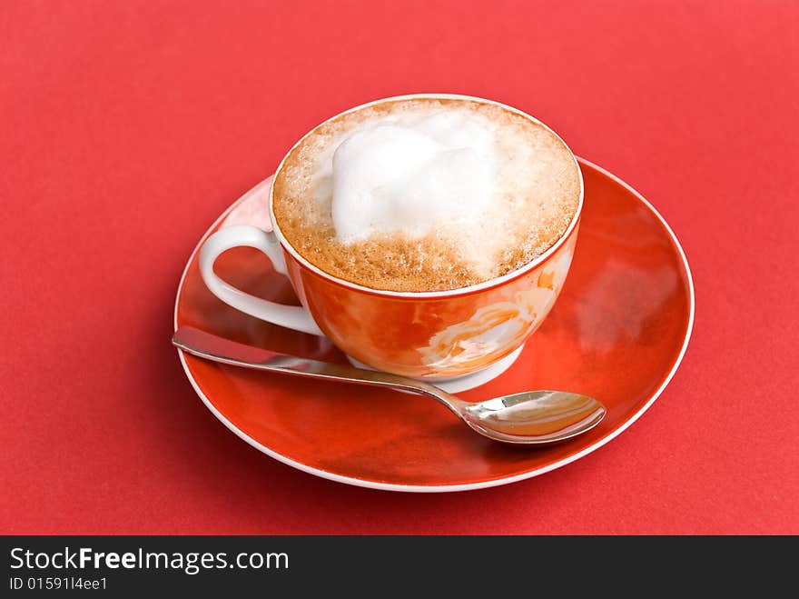 A cup of cappuccino with milk foam