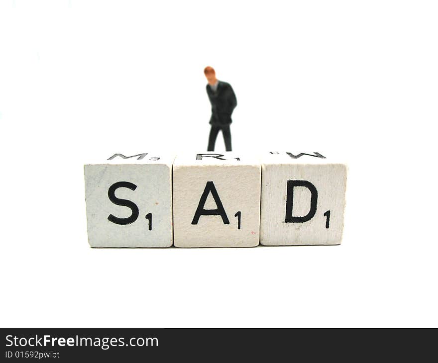 A man walking behind the word sad