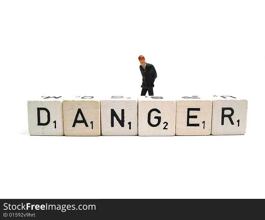 A figurine behind the word danger