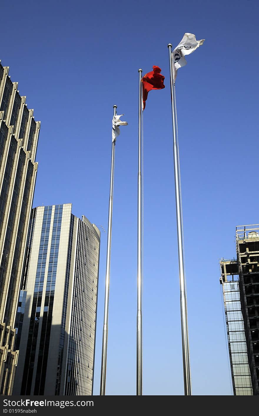 Flags in front of the building, Office building with blue sky. Flags in front of the building, Office building with blue sky