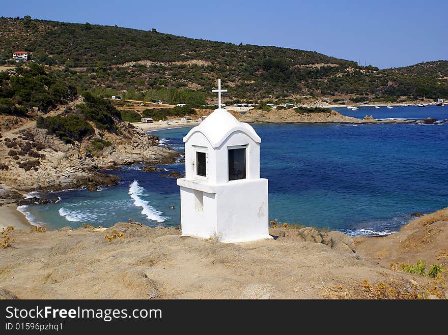 A white shrine in Sarti Beach overlooking the sea. A white shrine in Sarti Beach overlooking the sea.