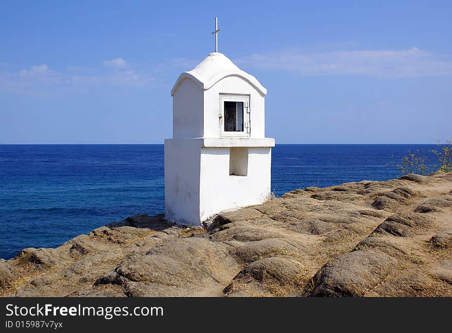 A white shrine in Sarti Beach overlooking the sea. A white shrine in Sarti Beach overlooking the sea.