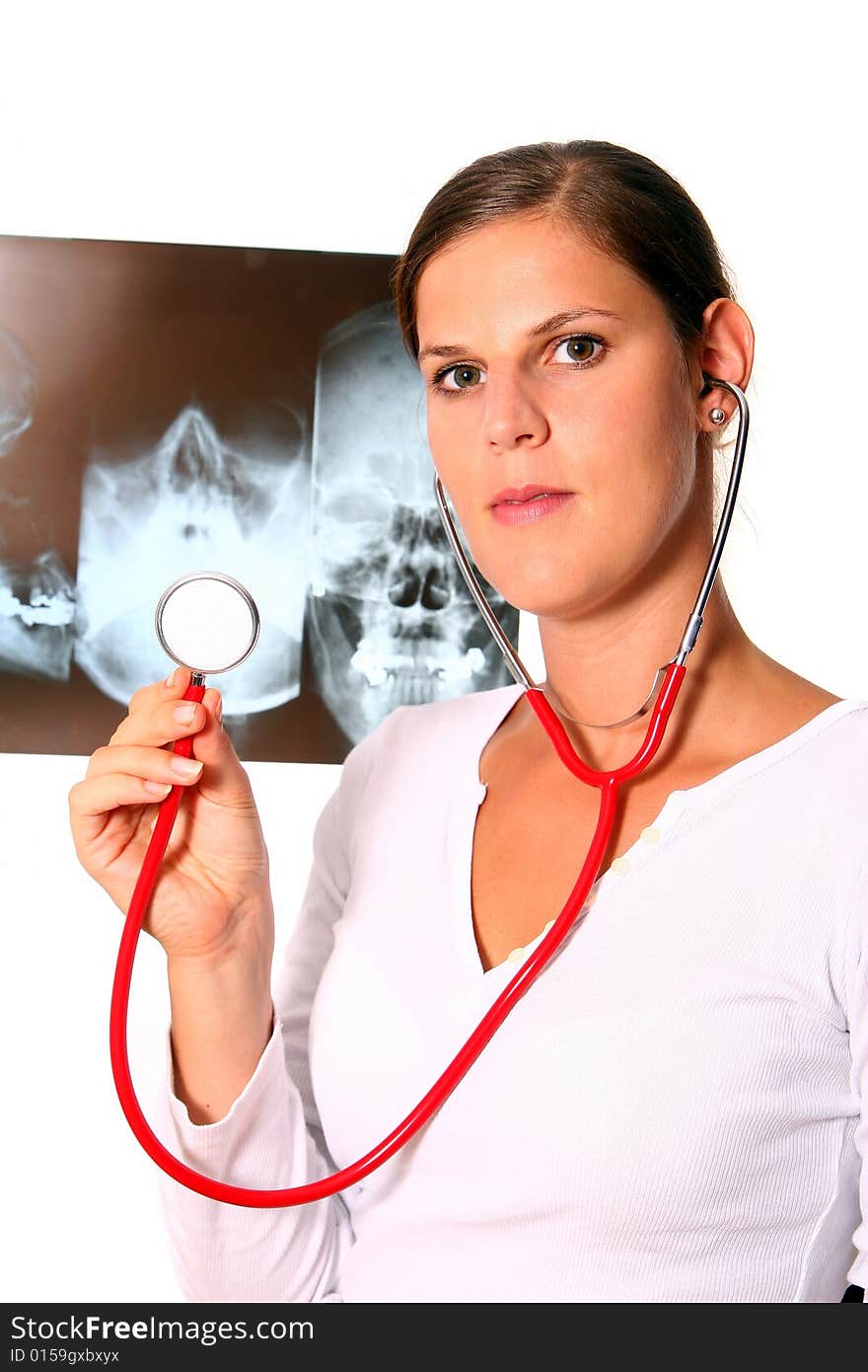 A beautiful young doctor with a red stethoscope and a xray image in the back. Isolated over white. A beautiful young doctor with a red stethoscope and a xray image in the back. Isolated over white.