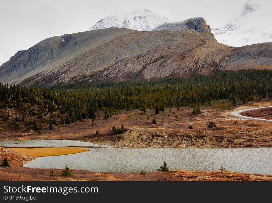 Glacier lake in the mountain in the early fall