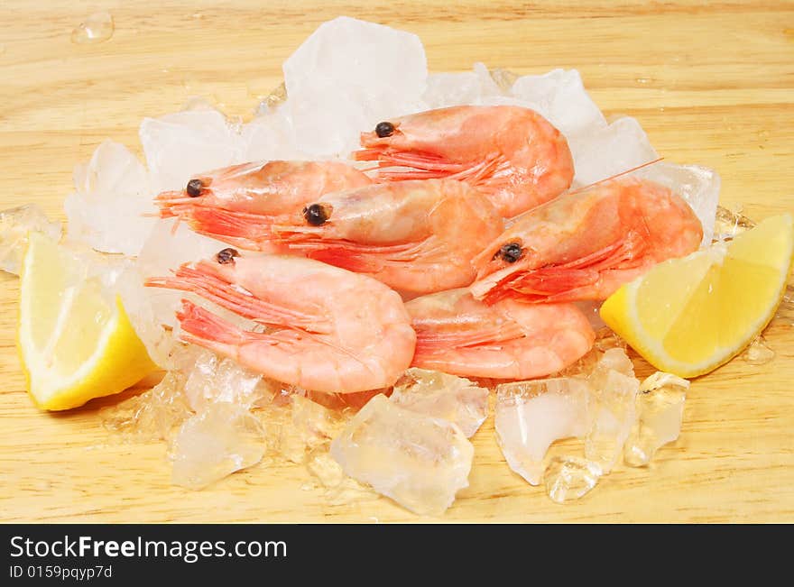 Shell on prawns with lemon on ice. Shell on prawns with lemon on ice