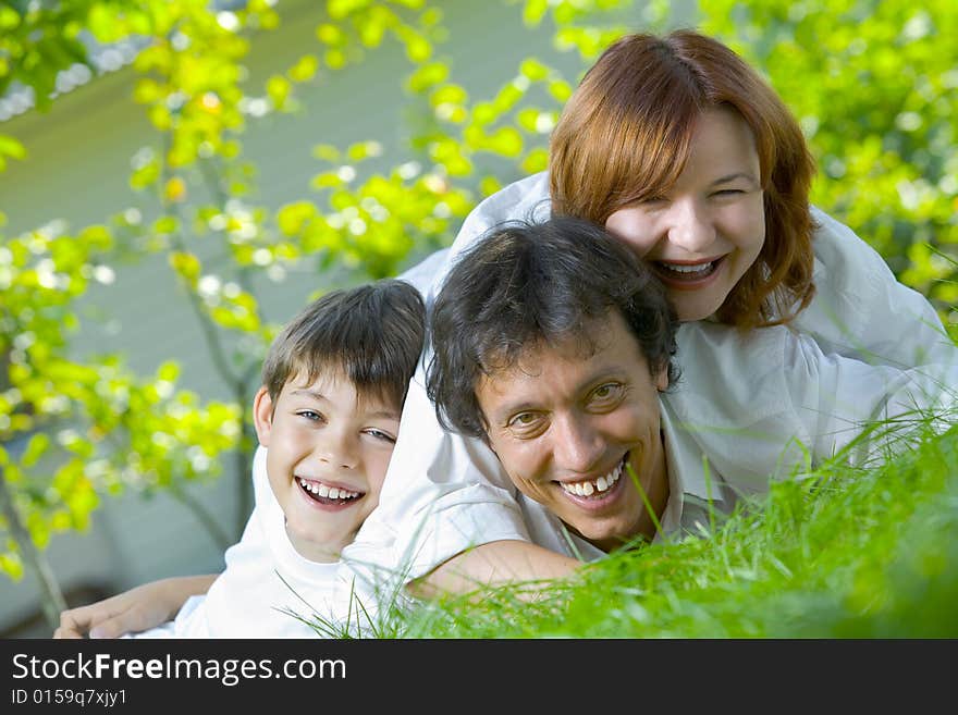 Portrait of young happy family in summer environment. Portrait of young happy family in summer environment