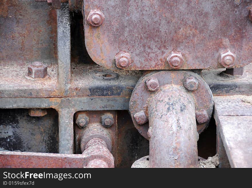 Close up photo of rusty bolts of an old machine