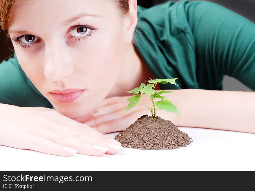 Beautiful young woman with green sprout of tree. Beautiful young woman with green sprout of tree