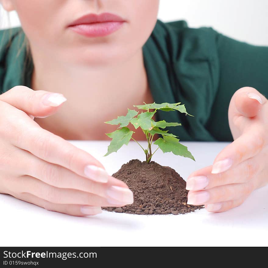 Young woman and green sprout