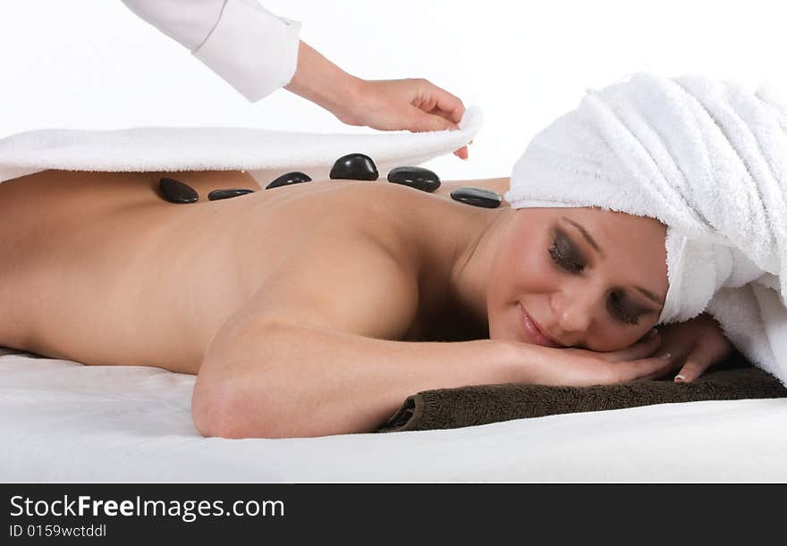 Pretty smiling lady getting hot stone massage