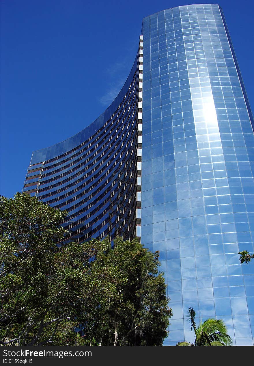 The skyscraper with sunlight reflections in San Diego downtown, California. The skyscraper with sunlight reflections in San Diego downtown, California.