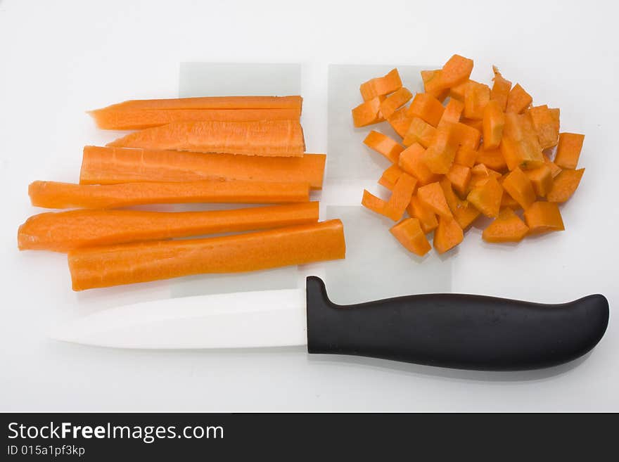 Sliced carrots and a knife on a chopping board