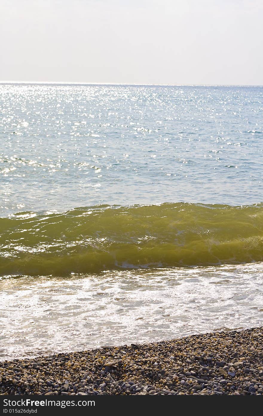 A wave crashing up the beach. A wave crashing up the beach