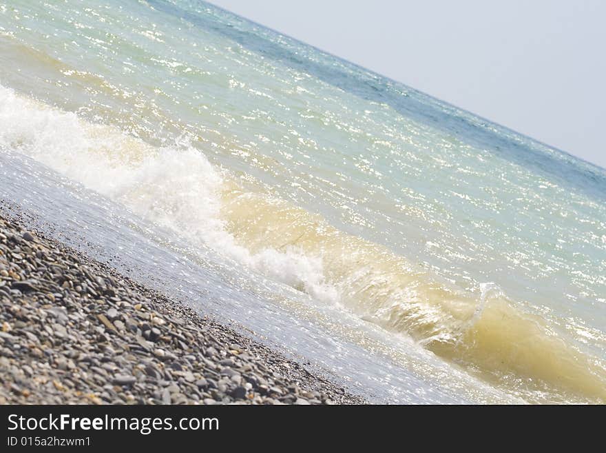 A wave crashing up the beach. A wave crashing up the beach