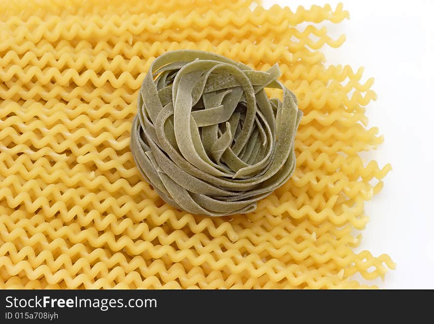 Raw pasta on bright background. Shot in Studio. Raw pasta on bright background. Shot in Studio.