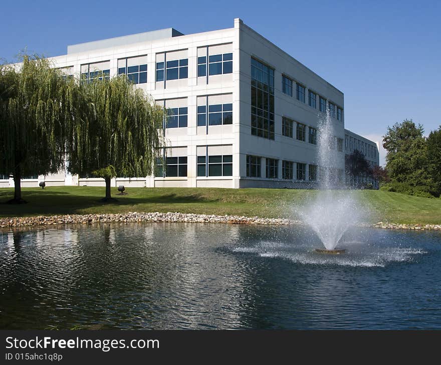 A modern office building with a pond and fountain