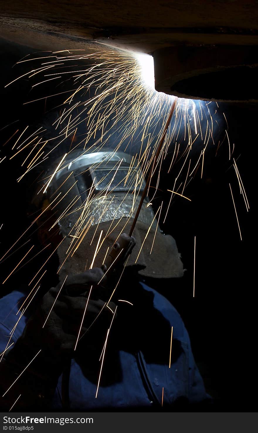 A welder working at shipyard at night. A welder working at shipyard at night