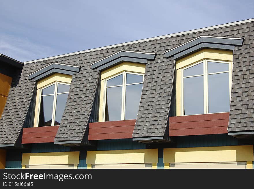 Detail of a house roof with three windows