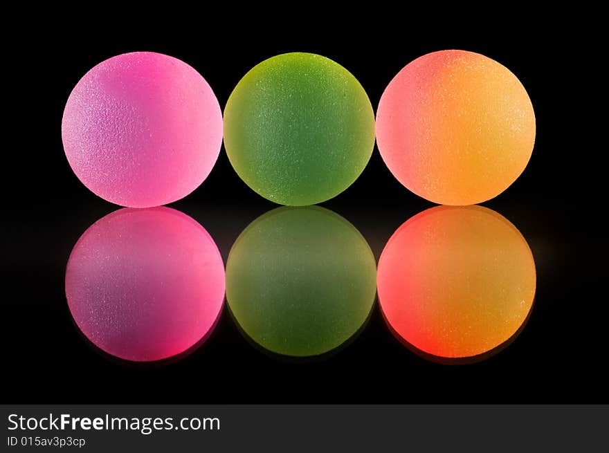 Stylish colorful balls with reflection. Isolated on black background