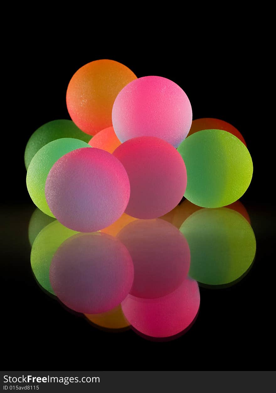 Stylish colorful balls with reflection. Isolated on black background