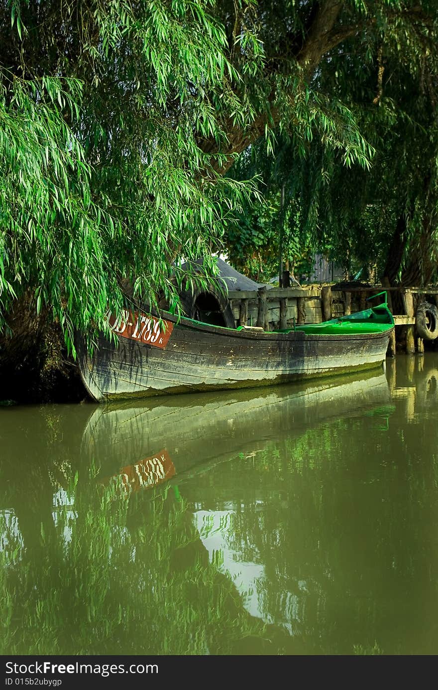 Traditional wooden boat at the river, Vylkove, Odes'ka Oblast, Ukraine. Traditional wooden boat at the river, Vylkove, Odes'ka Oblast, Ukraine