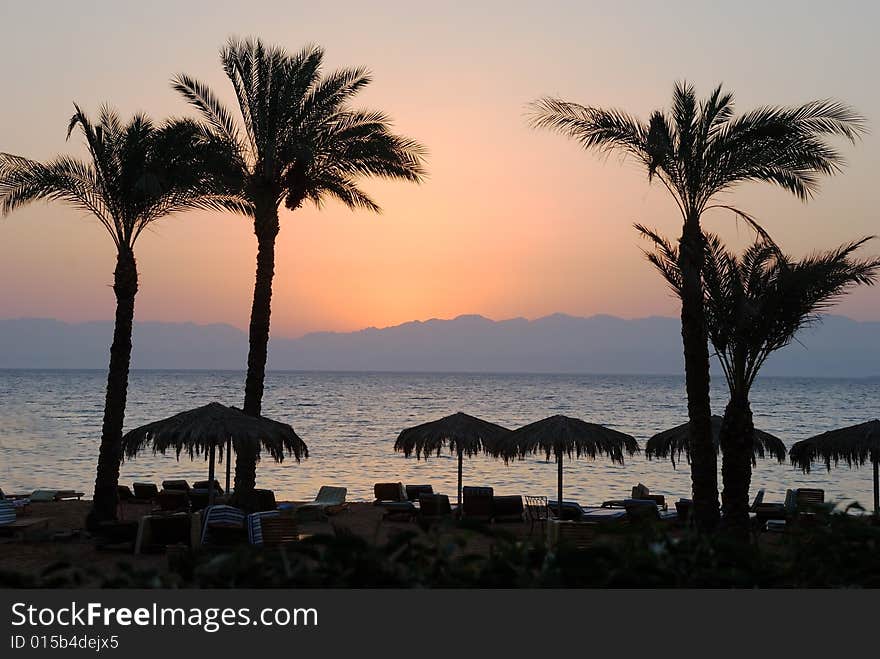 Morning on a beach, deck-chairs cost under palms, a sun did not yet appear from mountains. Morning on a beach, deck-chairs cost under palms, a sun did not yet appear from mountains