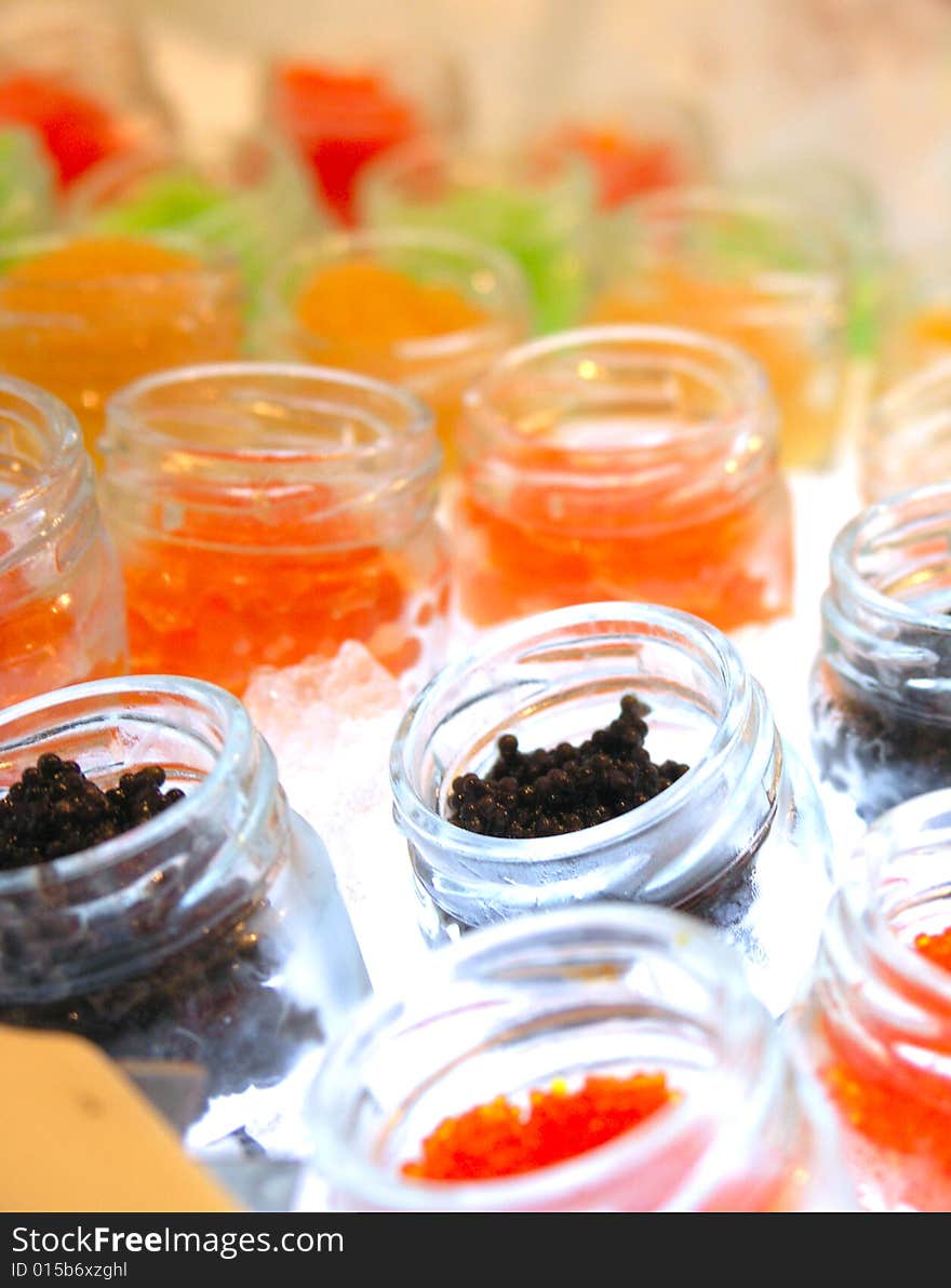 Colourful caviar delicacy inside mini bottle with ice cooler